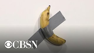 Artist sells banana ducttaped to wall for 120000 at Art Basel [upl. by Esojnauj]